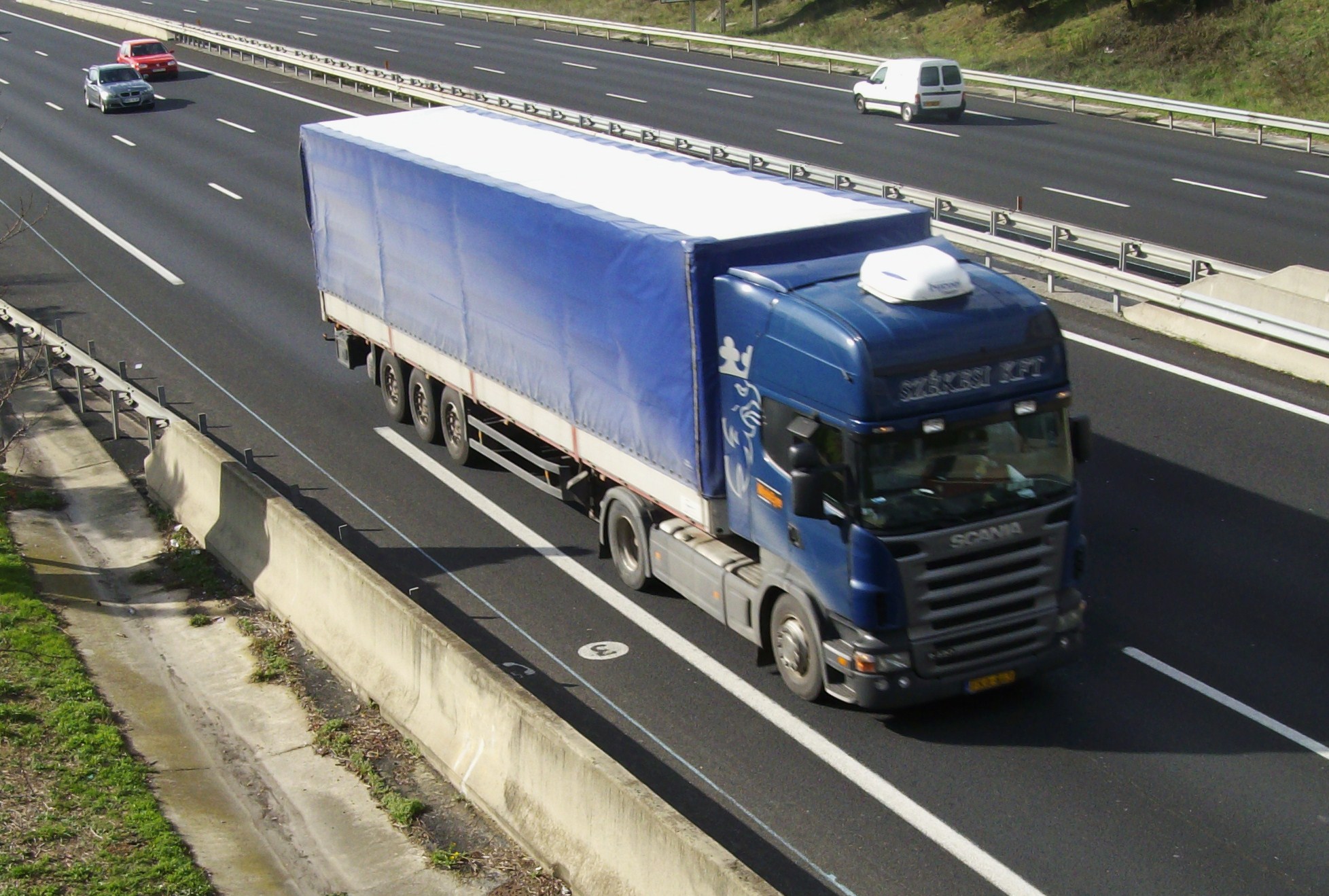 the truck is travelling down the road toward a stop