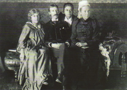 a black and white pograph of a family posing for a picture
