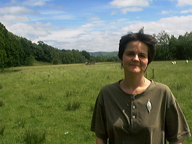 a woman is standing in a field in the middle of her underwear