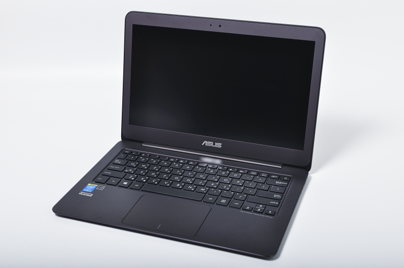 a black asus notebook with a screen on a table