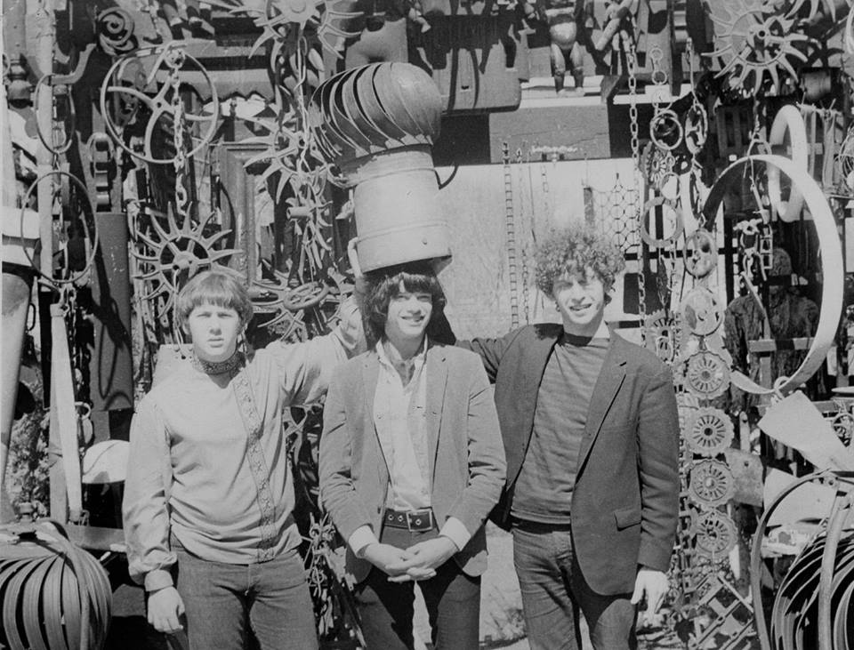 three people standing near a display of electrical equipment