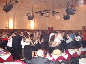 many people in a large ballroom at a party