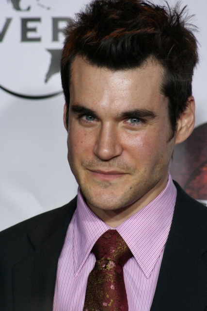 a man wearing a pink shirt, tie and jacket