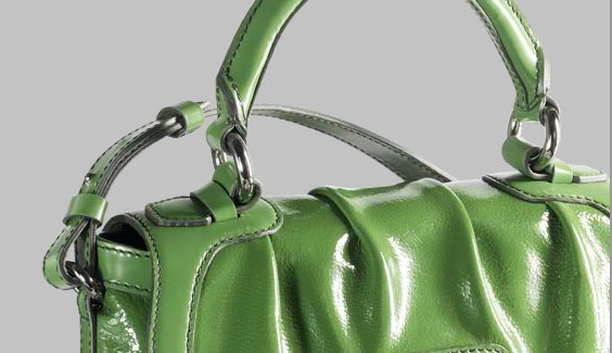 green handbag, one handle still attached to strap