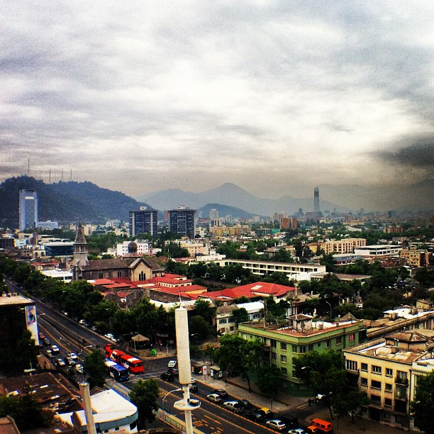 the city skyline in a cloudy day taken from the top of a tower