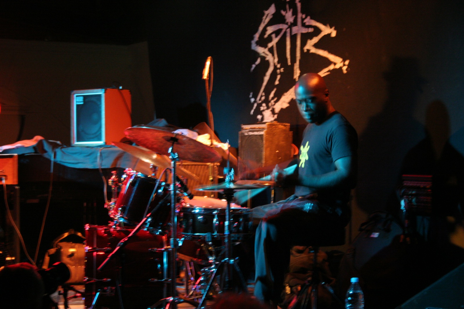 man sitting at a stage playing drums on drums