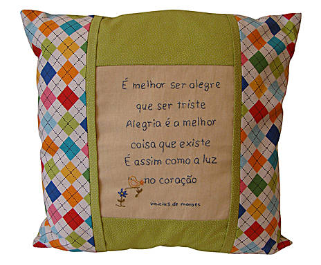 a colorful pillow with an embroidered message on the pillow