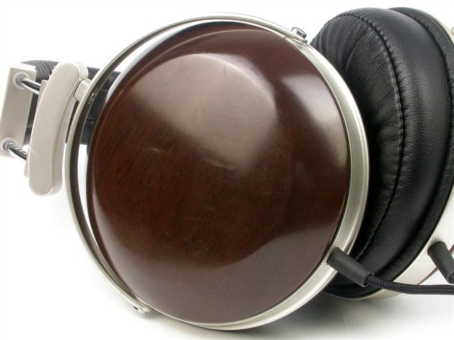 a headphones with a wooden case sitting on a table