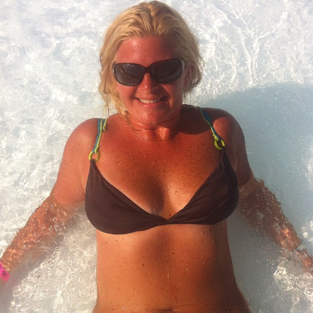 a beautiful blonde woman in a bikini laying down