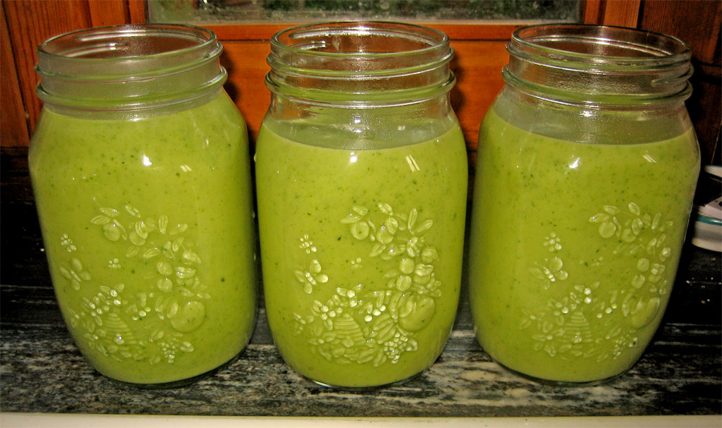 four mason jars filled with a green beverage