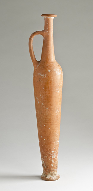 an old terracotta vase with a curved face and handle