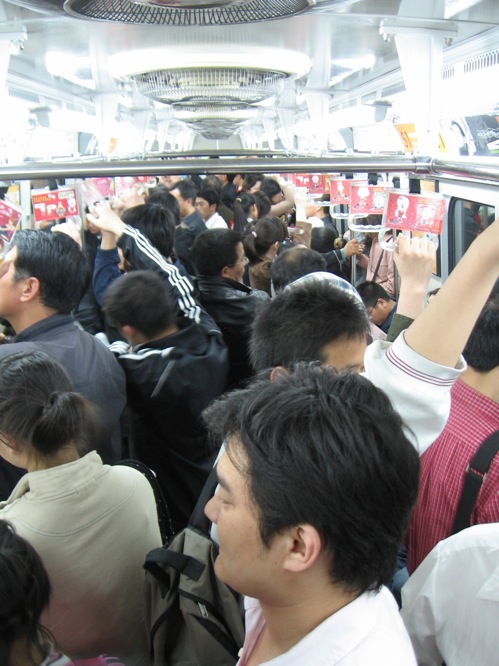 a group of people riding on the back of a bus