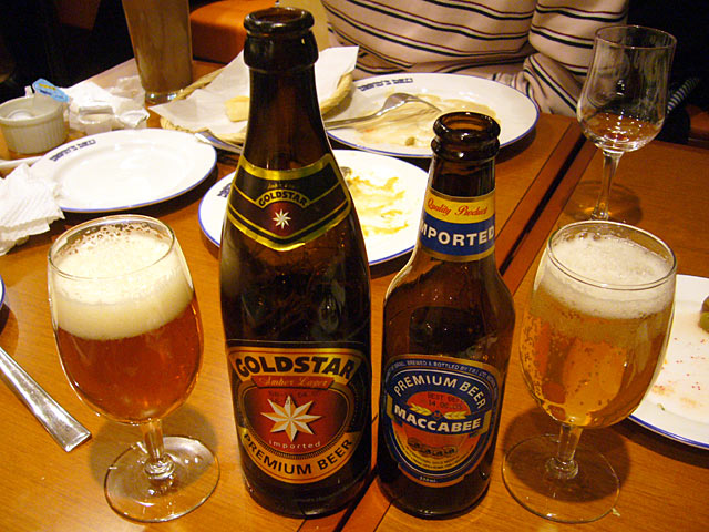 three bottles of beer are on a wooden table