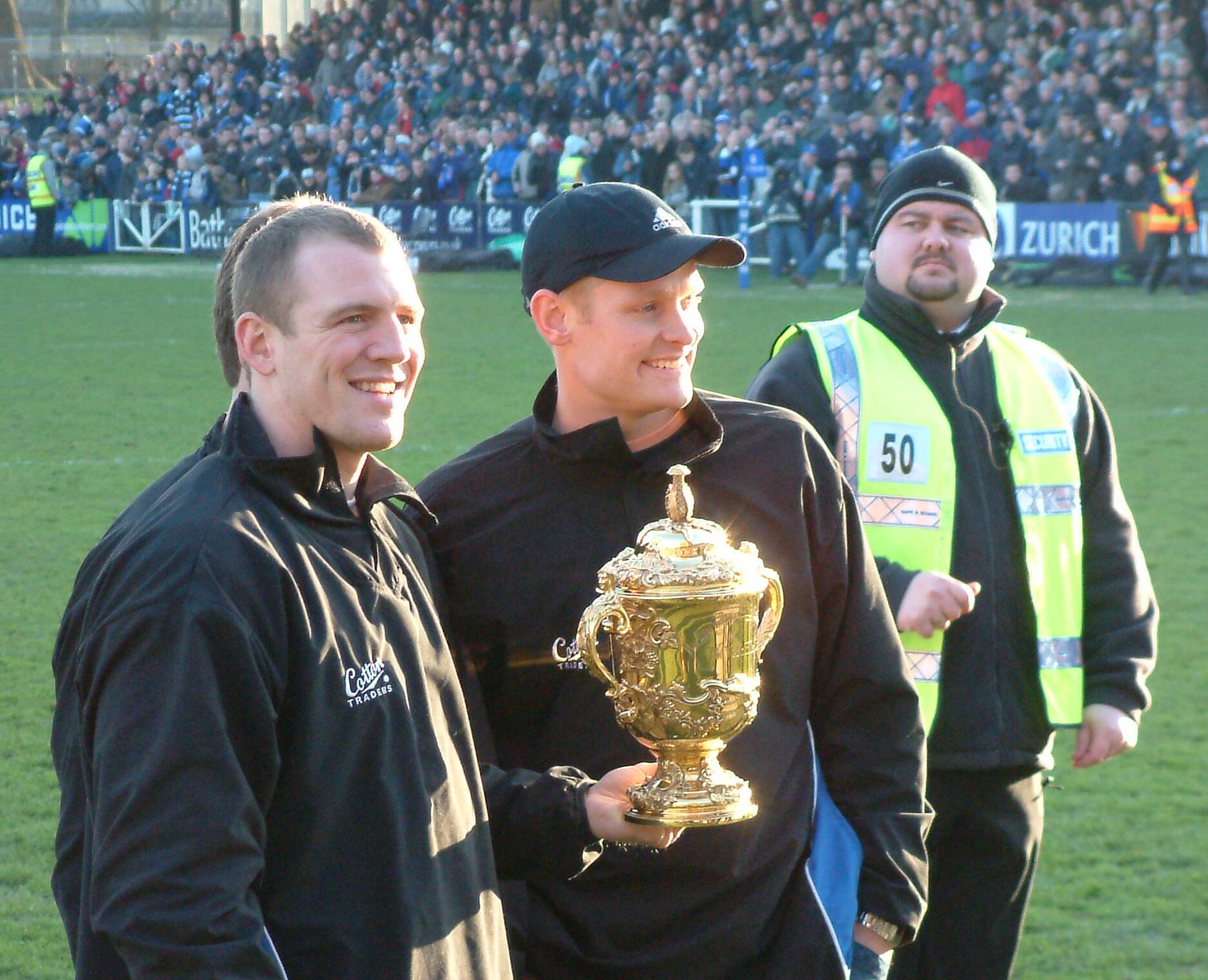a group of people holding a trophy while standing on a field