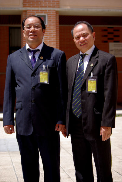 two asian gentlemen stand next to each other
