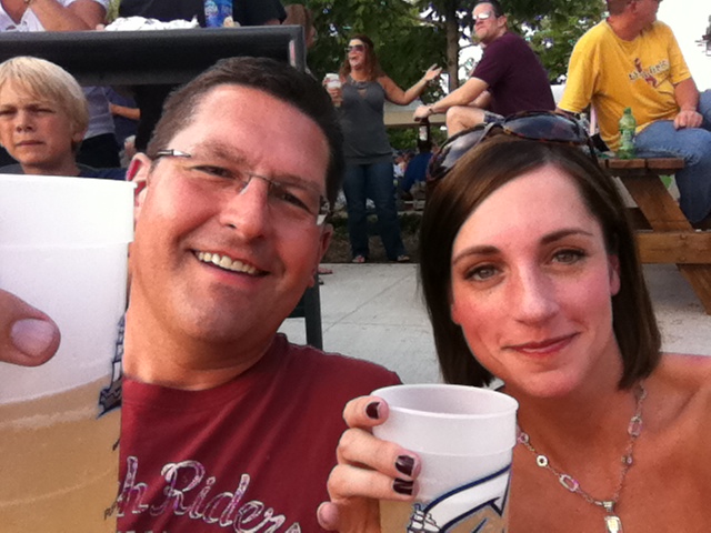 two people posing for a picture with coffee and people watching