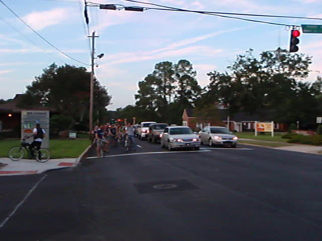 many cars waiting for people at an intersection