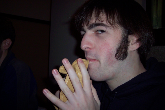 a young man is taking a bite of his sandwich