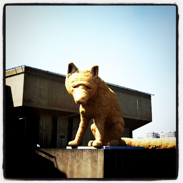 a big statue of a cat sitting on top of a table