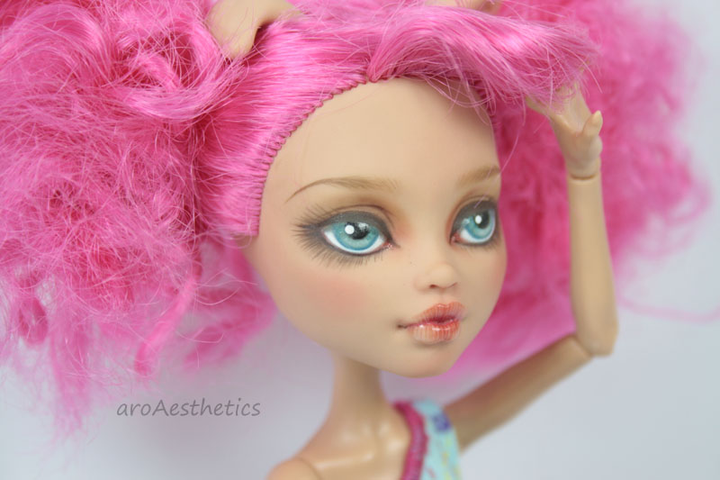 a doll has pink hair on it's head