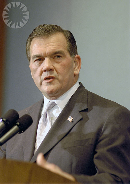 a man speaking to the public at a podium
