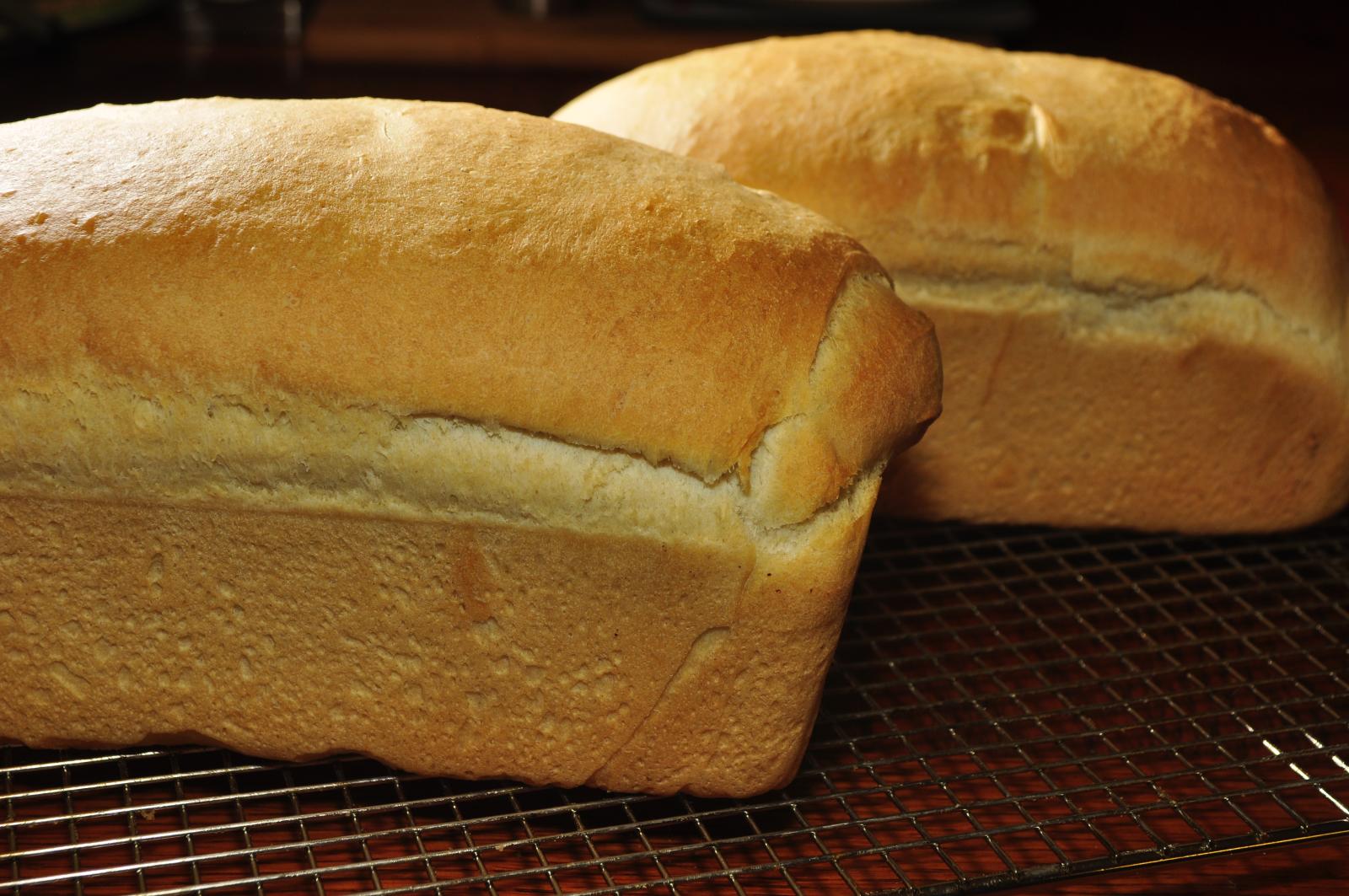 two loaves of bread on cooling rack