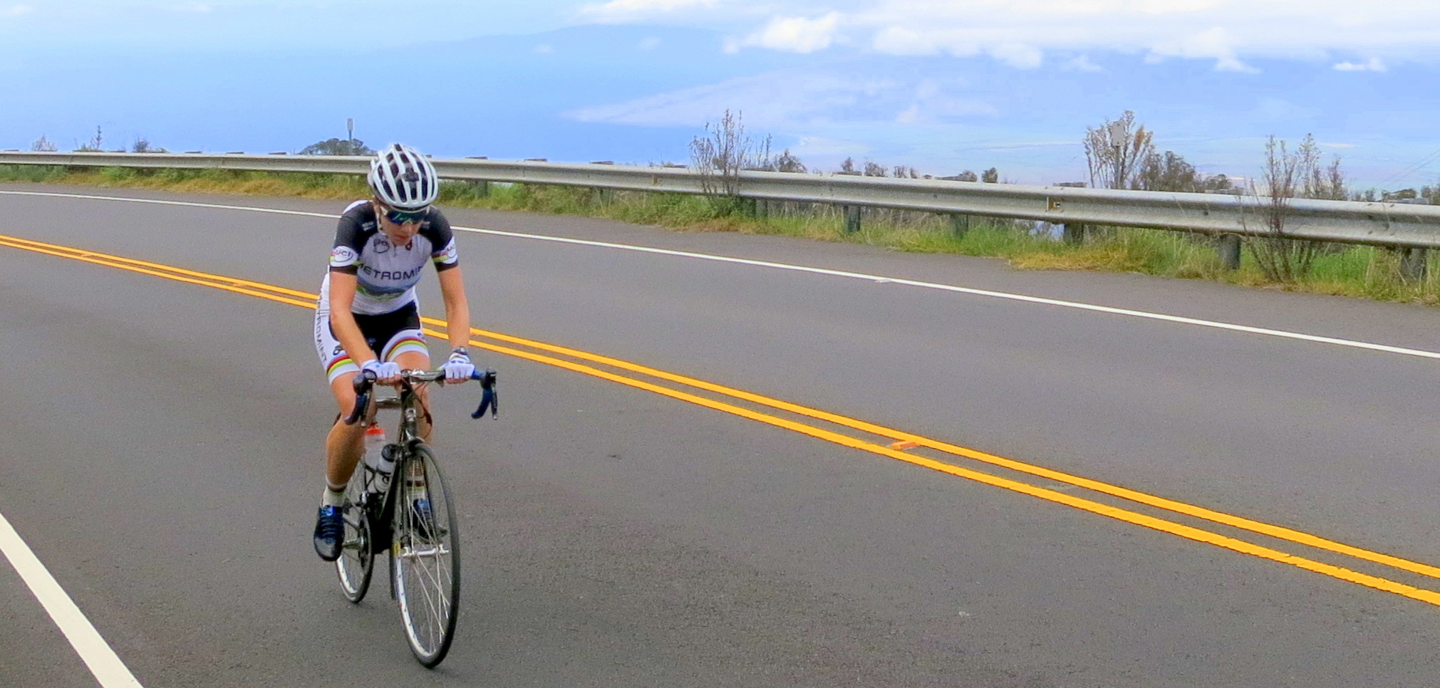 the man is riding his bicycle down the road