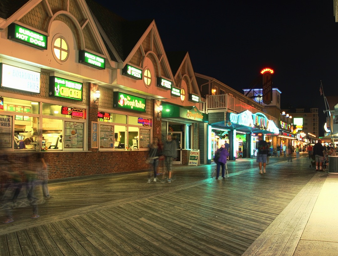 a street scene with people walking around in front of stores