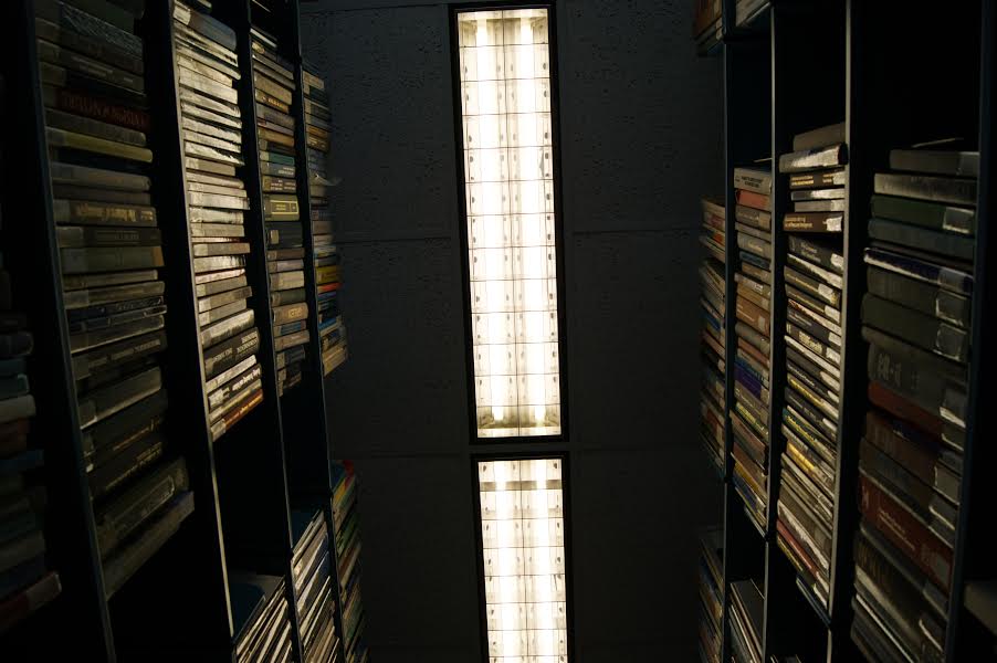 a narrow building with many bookshelves containing many books