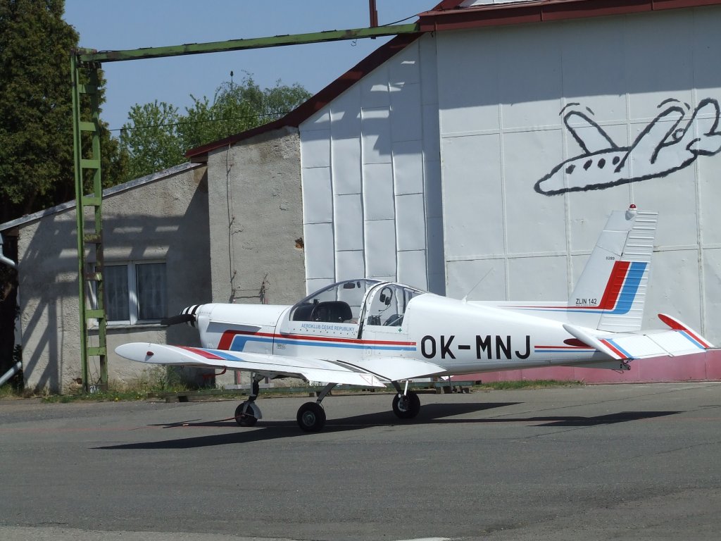 a white air plane sitting on top of an airport tarmac