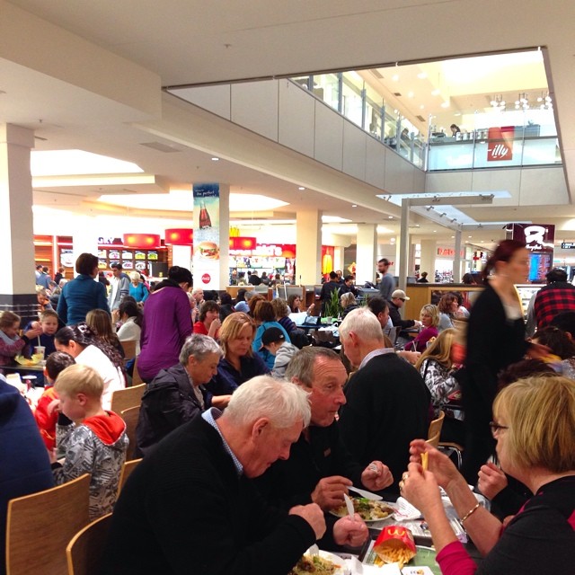 a group of people eating food at a buffet