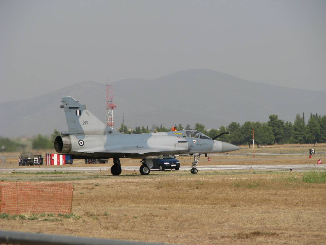 a large gray jet is parked on the runway