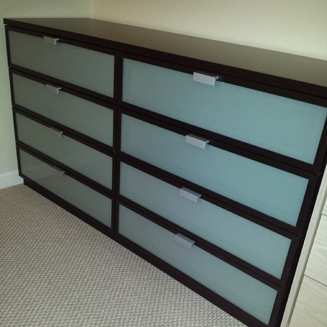 a black and blue dresser with clear drawers and cards