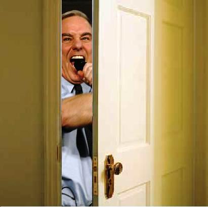 an older man standing behind a doorway opens his mouth