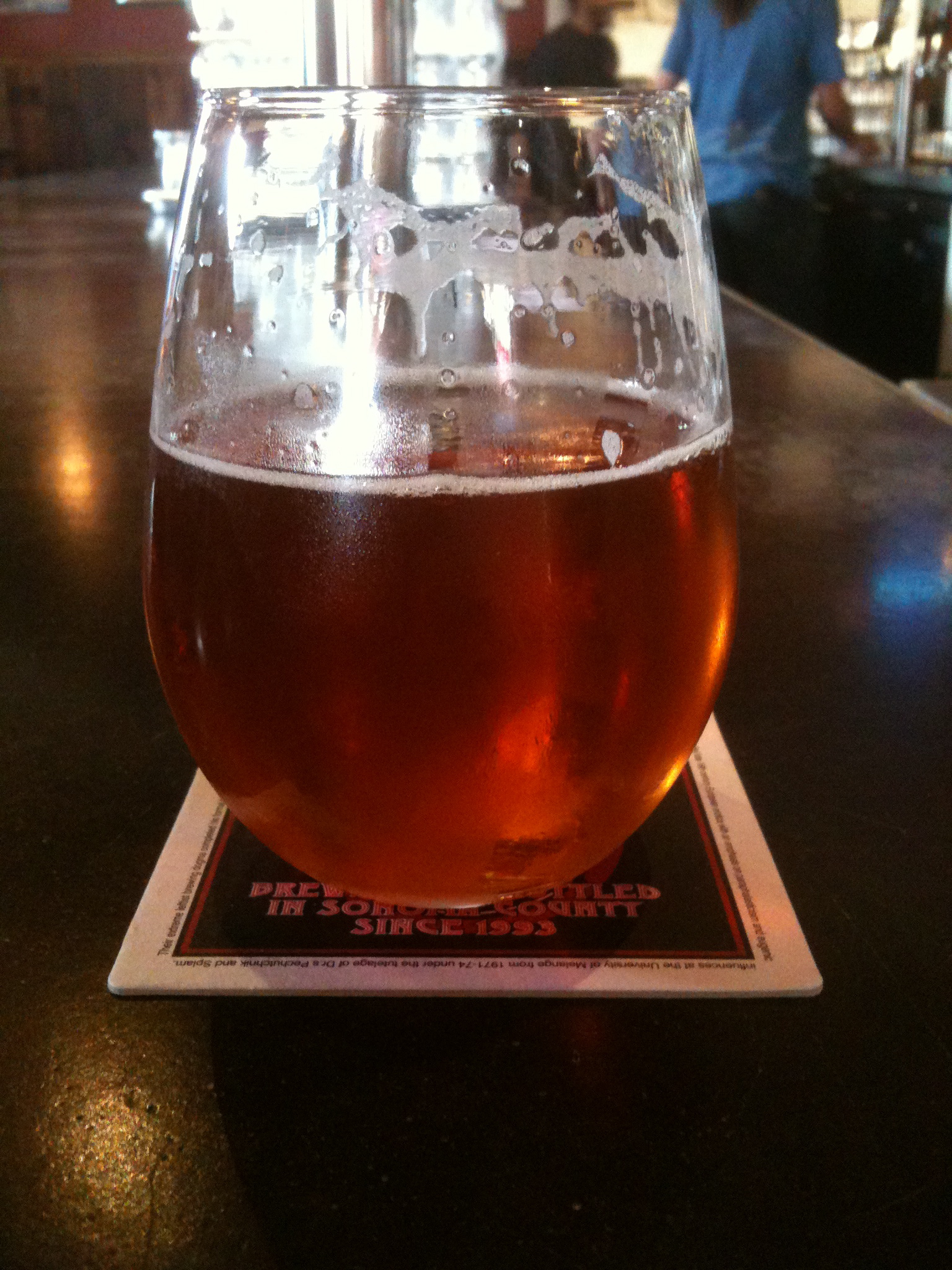 a close up view of a large beer glass on a bar