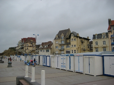 an empty beachfront with a bunch of buildings in the background