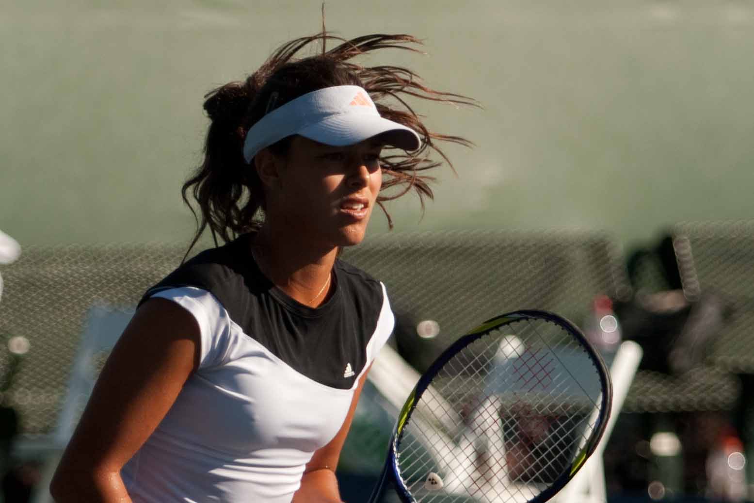 a woman swinging her tennis racket during a game