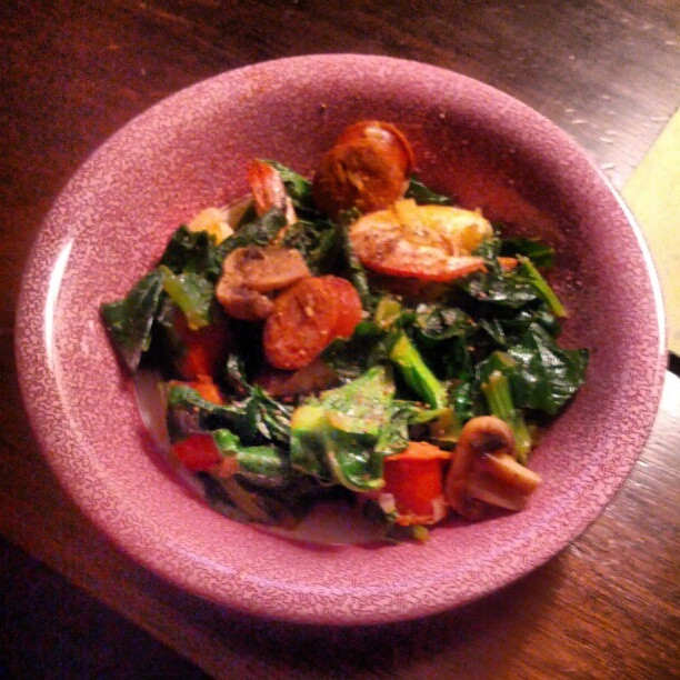 a pink bowl with some green and red vegetables