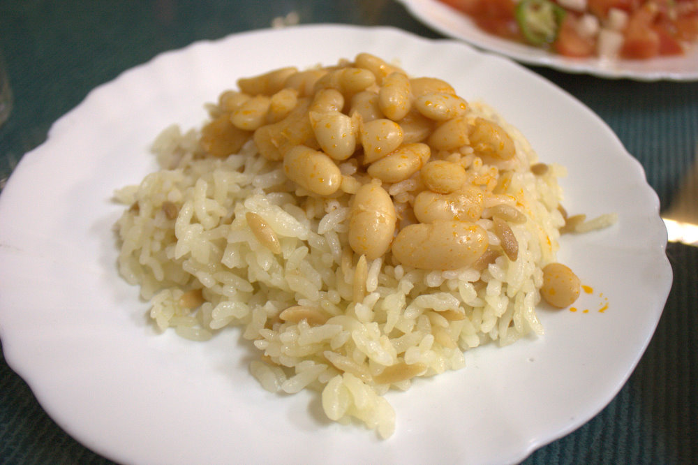 a white plate with rice and beans on it