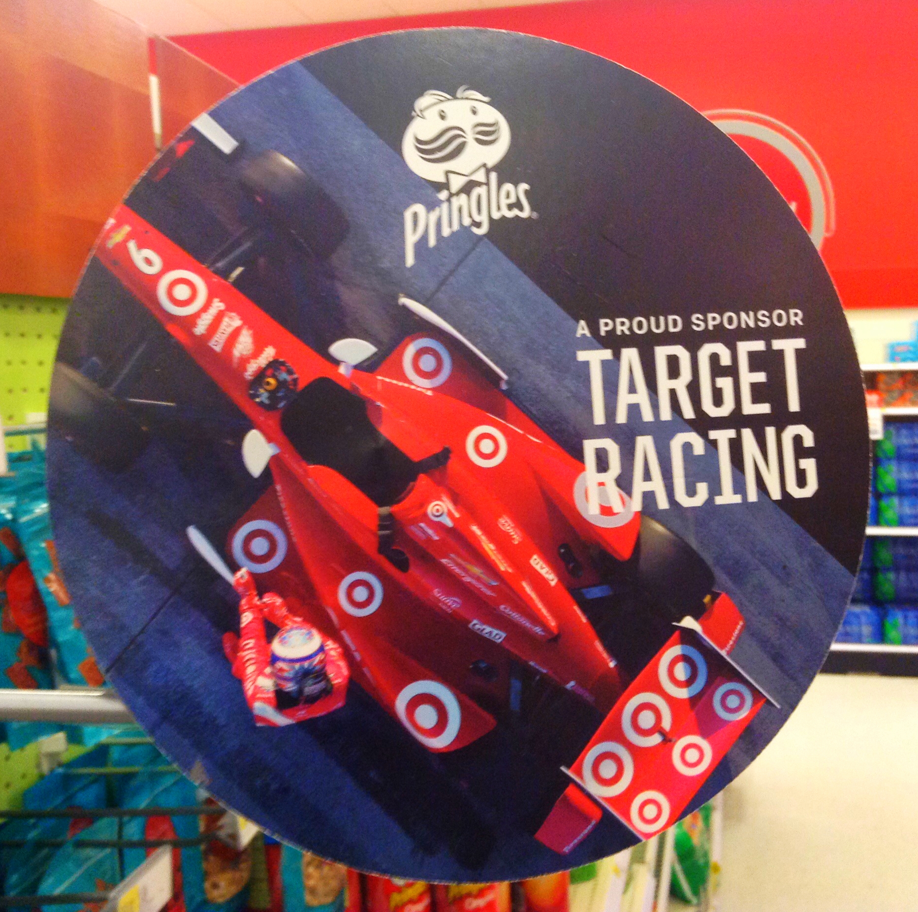 an advertising sign in a store with a race car