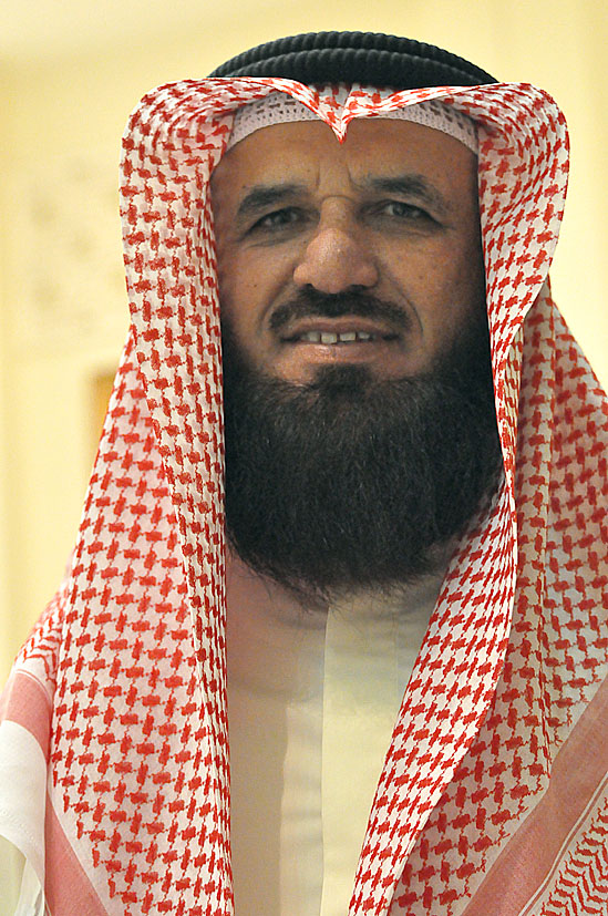 a man wearing an unusual head piece and a veil