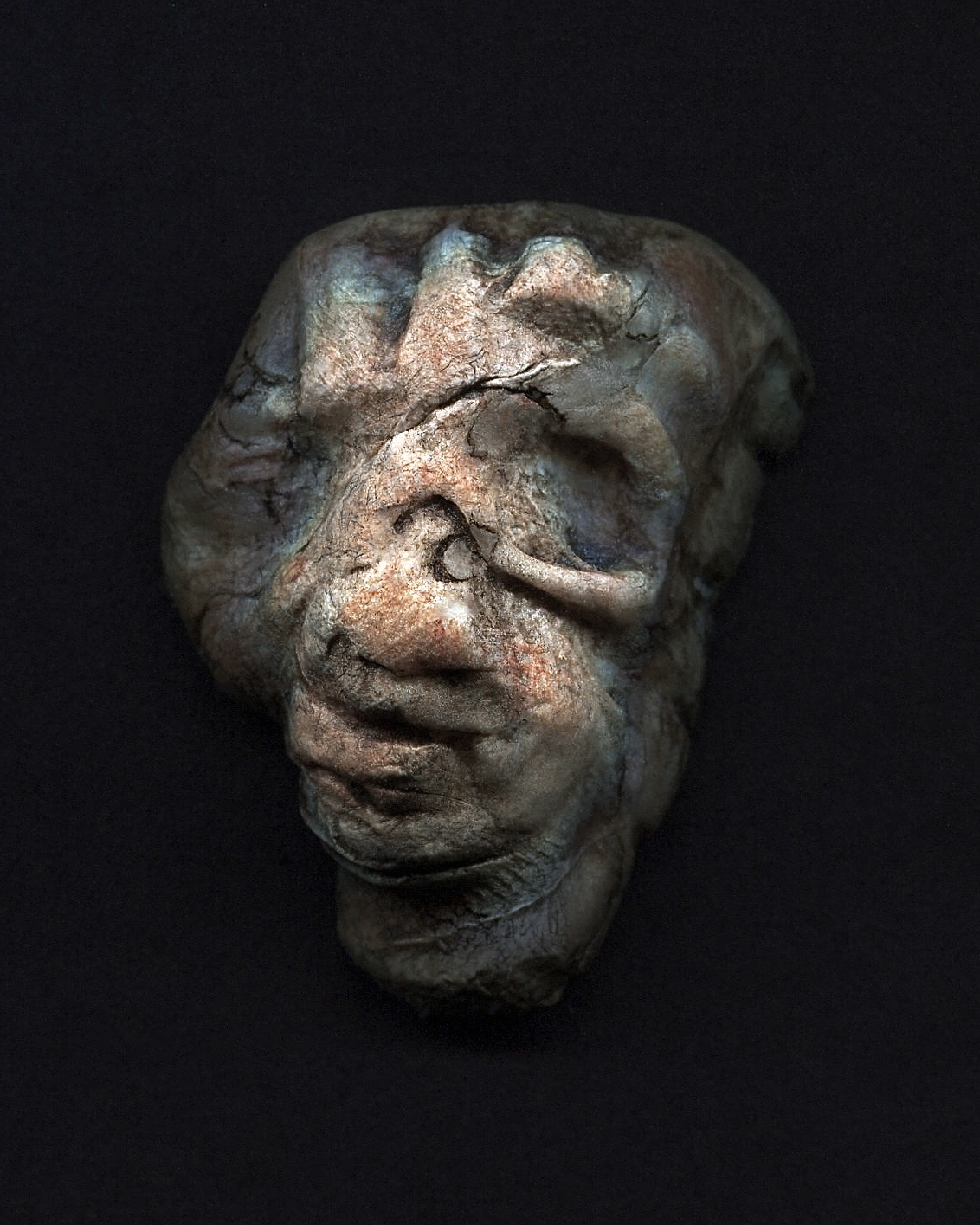 a very creepy looking stone on a black background
