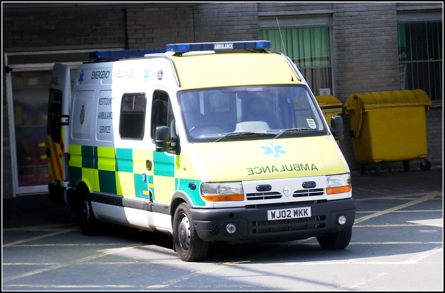 an ambulance is parked next to a street curb