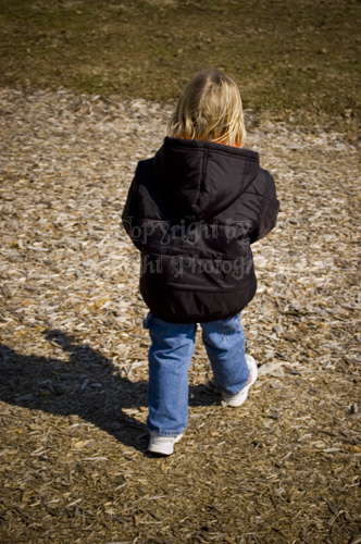 the young child is standing on top of the dirt