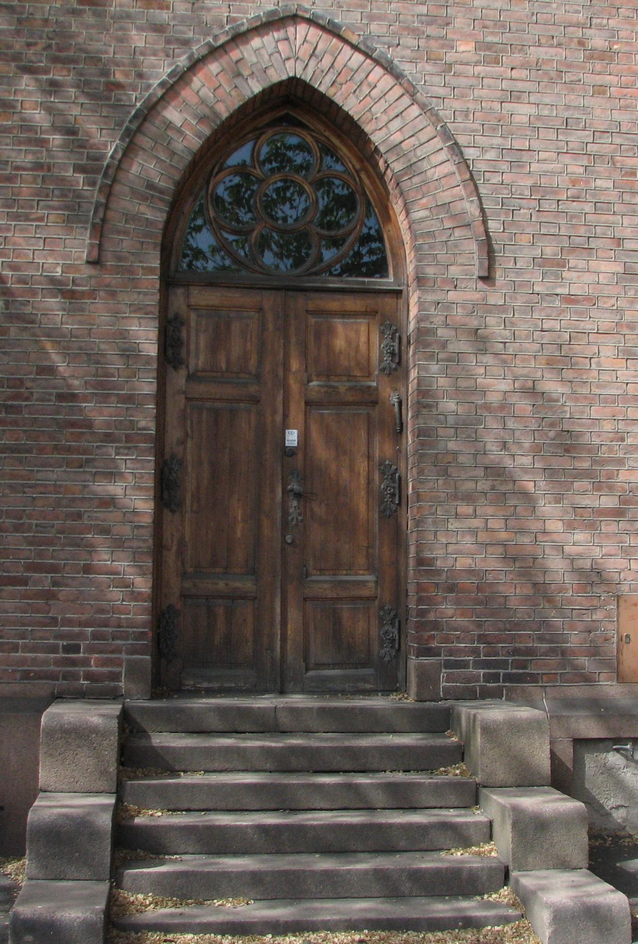 the front doors of an old church and stair case