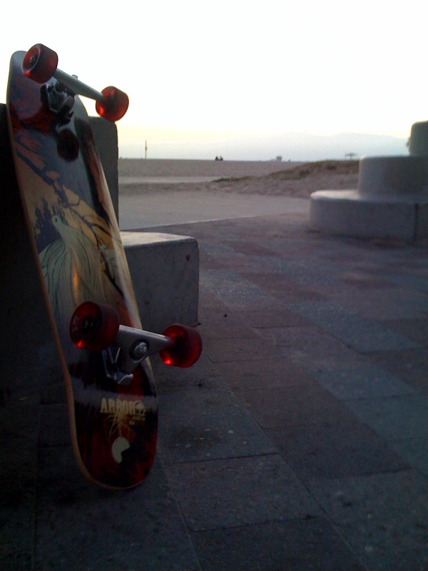 a skateboard is shown against the backdrop of an empty walkway