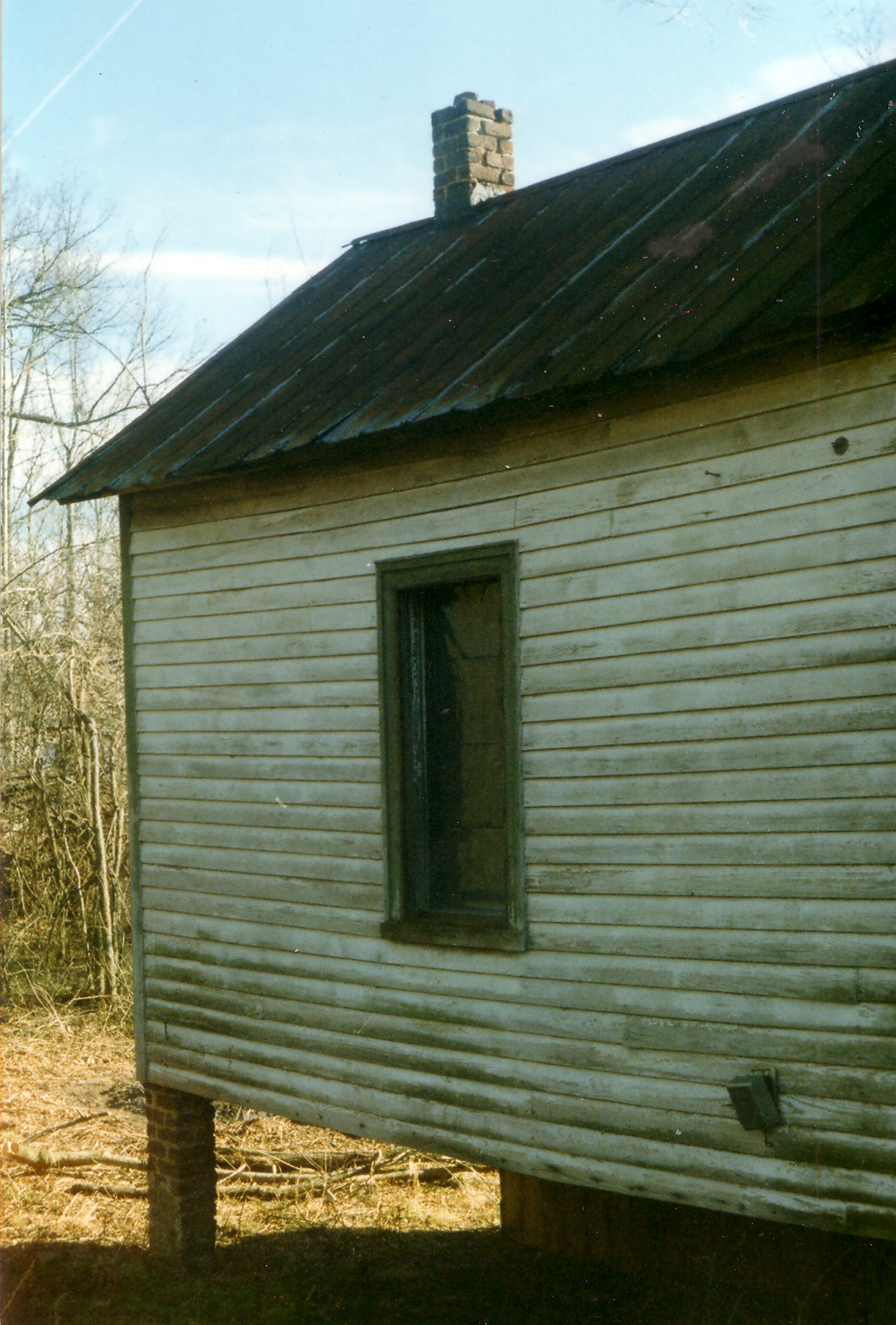 an old house with no window and some metal roof
