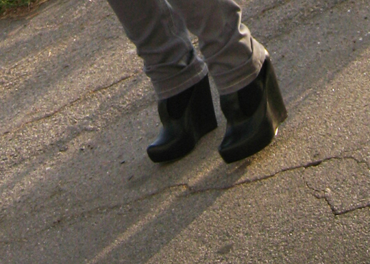 a man with black boots and grey pants