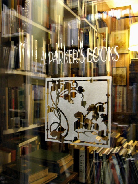 a window display with books in front of a glass
