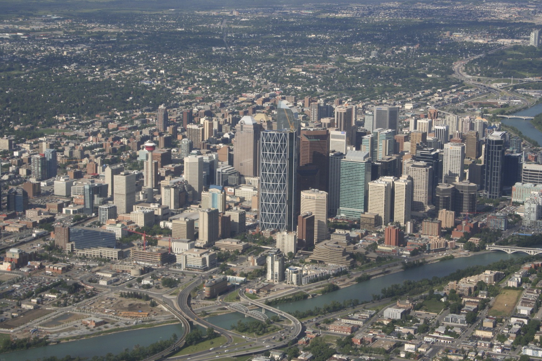 an aerial view of a city with some water and buildings